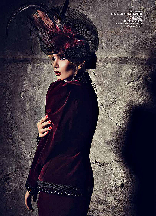 The model is wearing a velvet Yves Saint Laurent suit from the 1970s