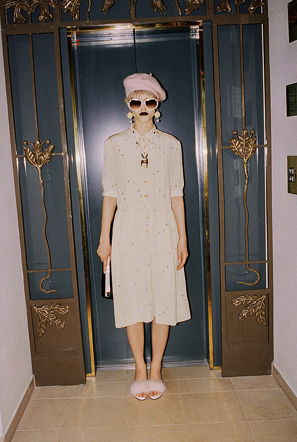 Chanel silk dress, Hobe necklace with a horse pendant, a quilted handbag by Chanel, Castlecliff clip-on earrings, and white Ted Lapidus sunglasses