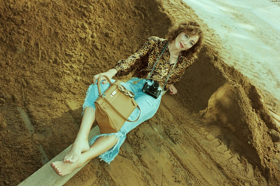 Alina wearing Christian Dior silk blouse, Chanel belt with medallions and Hermès Kelly 35 bag In Togo leather.