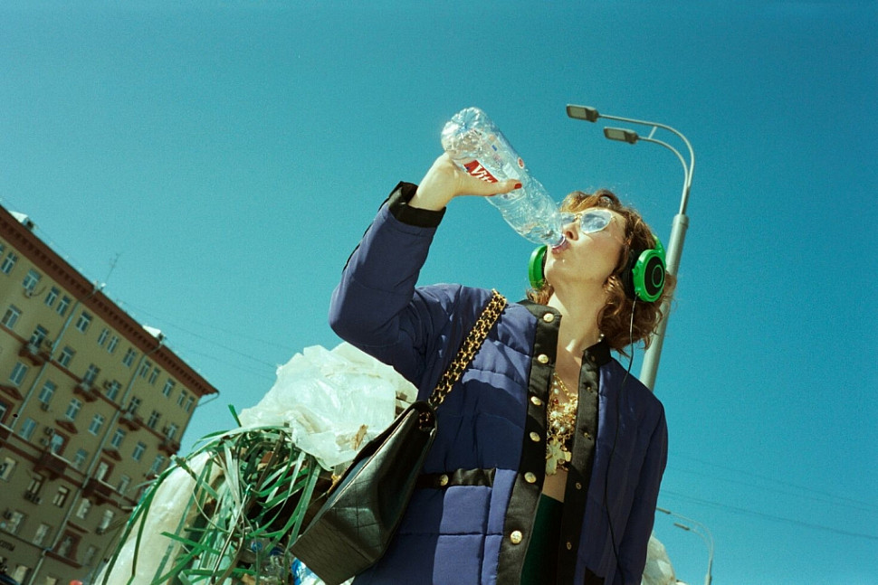 Alina wearing Chanel silk bomber jacket, Chanel baroque logo charm necklace, Chanel couture necklace with gripoix cross pendant, Chanel baroque bracelet and Chanel Jumbo Black Bag.