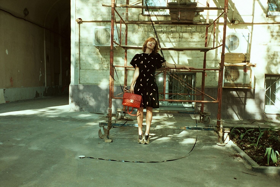 Alina wearing Holly Harp velvet dress and Chanel red backpack.